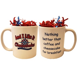 Twelve ounce white coffee mug with the And I Like It logo printed on front and quote "Nothing better than coffee and cheesecake for breakfast" on the back.
